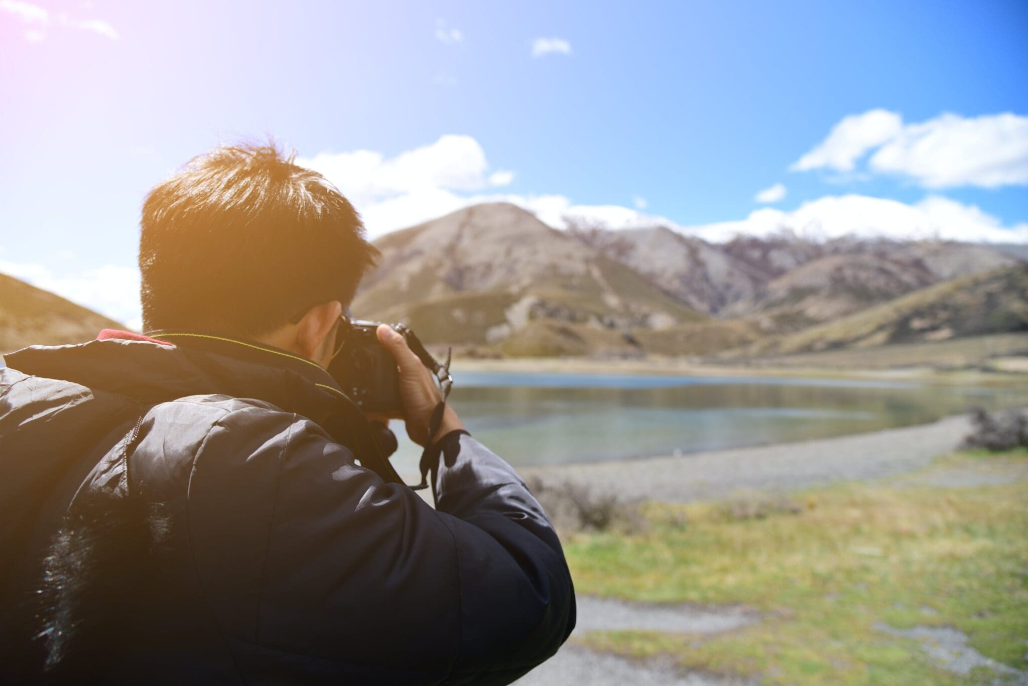 A man taking a picture of the mountains